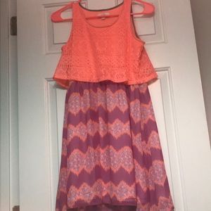 A sleeve-less pink and purple dress